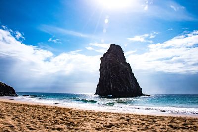 Scenic view of rocks on beach against sky