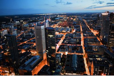 High angle view of illuminated buildings against sky at dusk