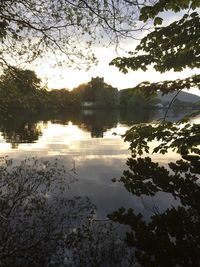 Scenic view of lake against sky at sunset