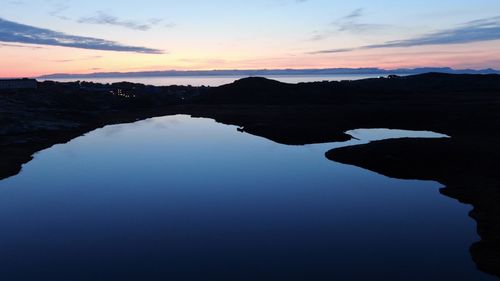 Scenic view of lake against sky during sunset