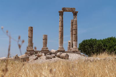 Old ruins on field against sky