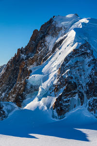 Scenic view of snowcapped mountain against clear blue sky