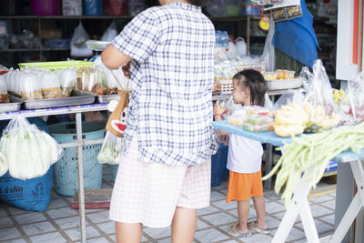 Rear view of woman standing at market