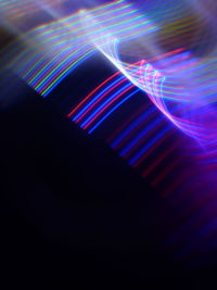 Close-up of illuminated lights against black background