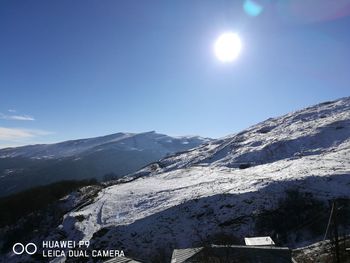 Scenic view of snowcapped mountains against clear sky