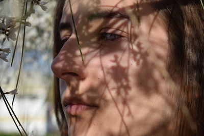 Close-up portrait of a young woman looking away