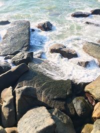 High angle view of rocks at sea shore