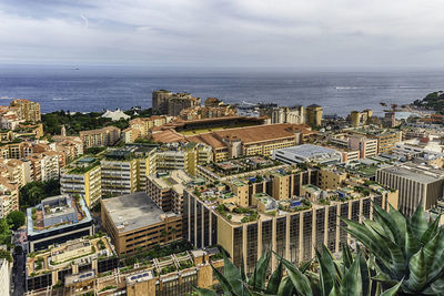 High angle view of buildings by sea against sky