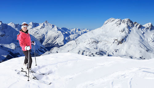 Portrait of woman skiing on snowcapped mountain