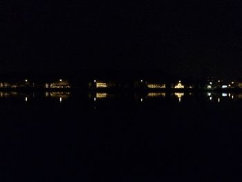 Illuminated buildings against sky at night