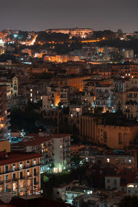 High angle view of illuminated townscape against sky at night