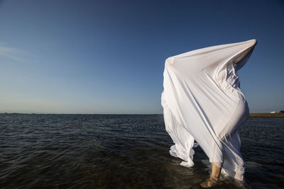 With white cloth wet on the body inside the sea water