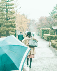 Rear view of women walking on road