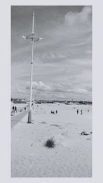 People on beach against sky