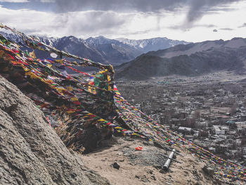 Panoramic view of buildings and mountains against sky