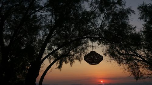 Silhouette trees against sky during sunset