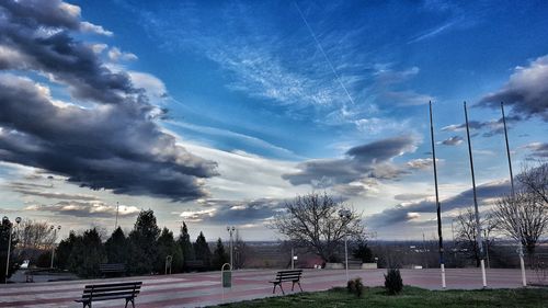 Panoramic view of people and trees against sky