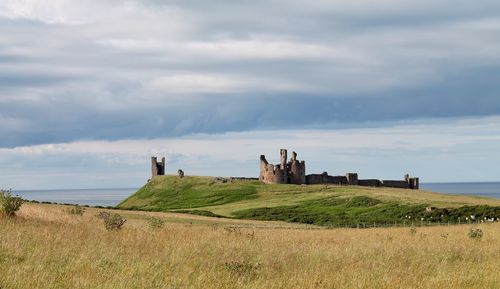 Built structure on field against sky
dunstanburgh castle 