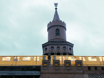 Low angle view of illuminated clock tower against sky