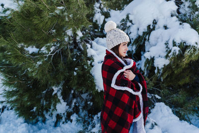 Man wearing hat on tree during winter