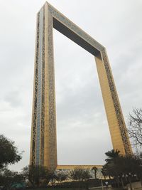 Low angle view of tower against cloudy sky