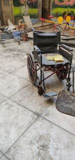 Empty chairs and tables on sidewalk