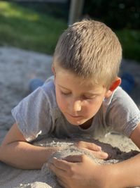 Side view of boy looking at beach