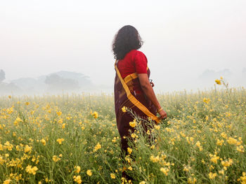 Rear view of person standing on field