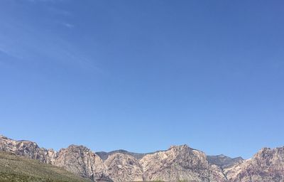 Scenic view of mountains against clear blue sky