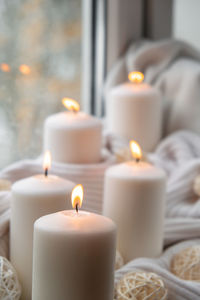 Close-up of illuminated candles on table