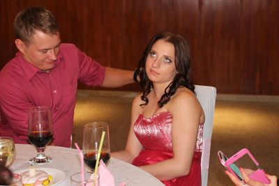 Young couple with red wine at table in restaurant