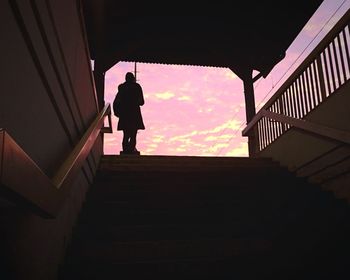 Low angle view of silhouette people against sky