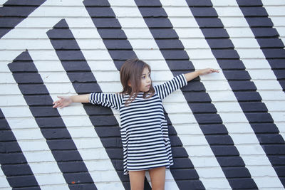 Woman standing with arms outstretched