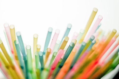 Close-up of colored pencils over white background