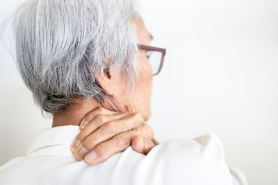 Rear view of man against white background
