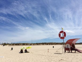 People on beach against sky