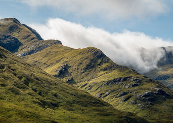 Scenic view of green mountain against sky