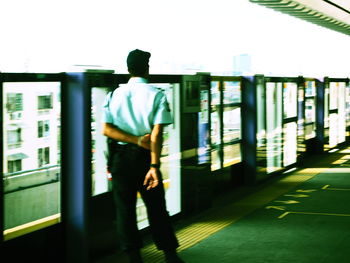 Man standing in front of railing