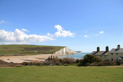 Field by sea against sky