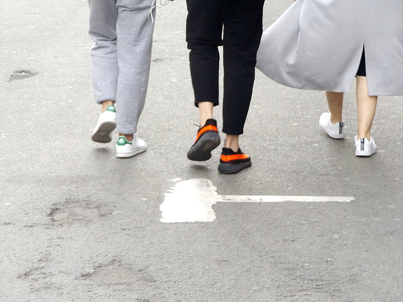 LOW SECTION OF PEOPLE WALKING ON ROAD