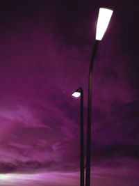 Low angle view of street light against cloudy sky