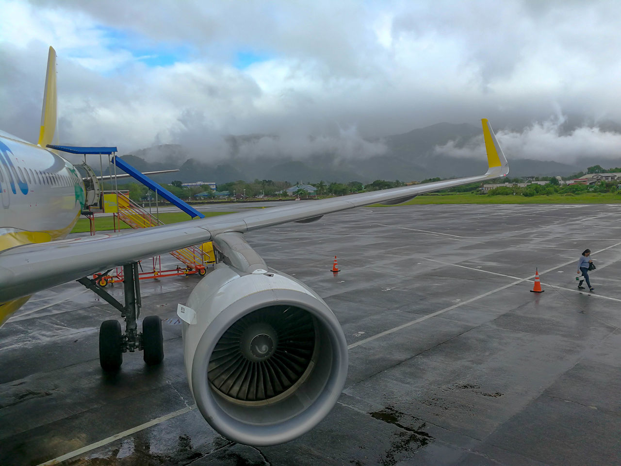 AIRPLANE ON AIRPORT RUNWAY AGAINST CLOUDY SKY