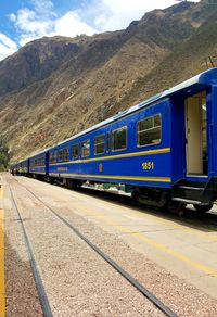 Train at railroad station platform against sky