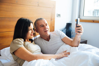 Couple relaxing on bed at home