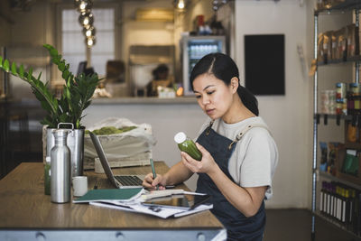 Young woman looking at table at home