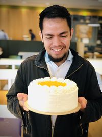 Portrait of smiling man holding ice cream