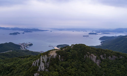 Scenic view of land and mountains against sky