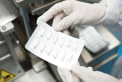 Cropped hands of doctor holding pills