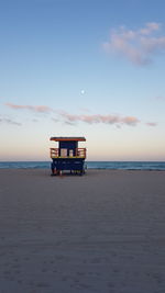 Scenic view of beach against sky during sunset