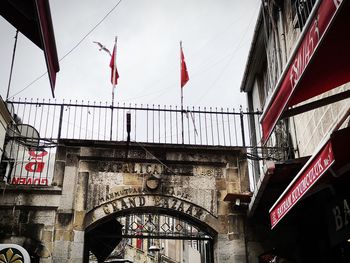 Low angle view of flag against buildings in city